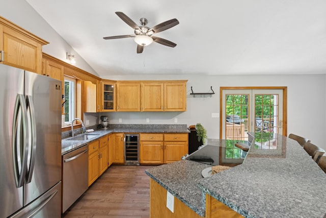 2288 W River Rd, Sidney, ME 04330 - kitchen featuring appliances with stainless steel finishes, wine cooler, wood finished floors, vaulted ceiling, and ceiling fan