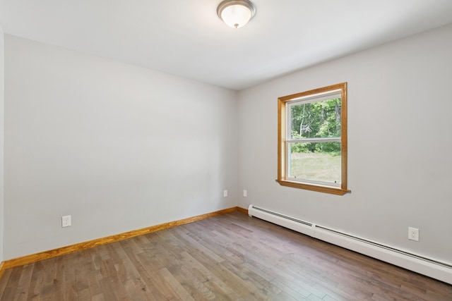2288 W River Rd, Sidney, ME 04330 - spare room featuring a baseboard radiator and wood-type flooring