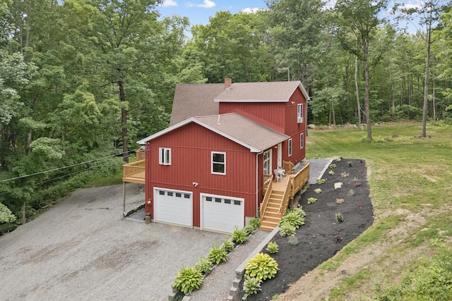2288 W River Rd, Sidney, ME 04330 - view of home's exterior with roof with shingles, stairway, driveway, an attached garage, and a deck