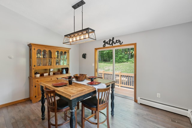 2288 W River Rd, Sidney, ME 04330 - dining room featuring baseboard heating, light wood-type flooring, and lofted ceiling