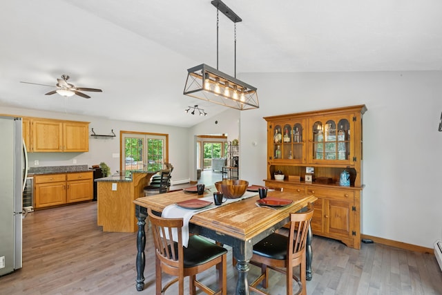 2288 W River Rd, Sidney, ME 04330 - dining space with lofted ceiling, light wood-style flooring, ceiling fan, and baseboard heating