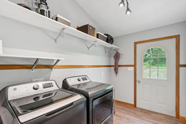 2288 W River Rd, Sidney, ME 04330 - washroom featuring washing machine and dryer and light wood-style flooring
