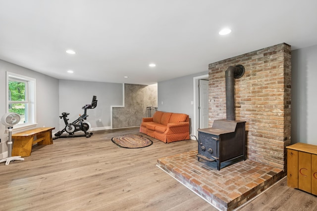 2288 W River Rd, Sidney, ME 04330 - living room with light wood finished floors, a wood stove, and recessed lighting
