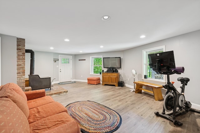 2288 W River Rd, Sidney, ME 04330 - living area featuring light wood-style floors, recessed lighting, and a wood stove