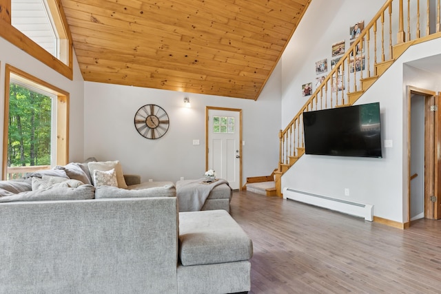 2288 W River Rd, Sidney, ME 04330 - living room featuring a baseboard radiator, stairway, wood ceiling, wood finished floors, and high vaulted ceiling