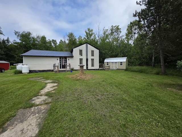 17 Cross St, Kingman Twp, ME 04451 - back of house featuring a lawn, a shed, a metal roof, and entry steps