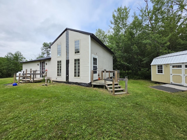 17 Cross St, Kingman Twp, ME 04451 - back of property featuring a deck, a storage shed, and a lawn