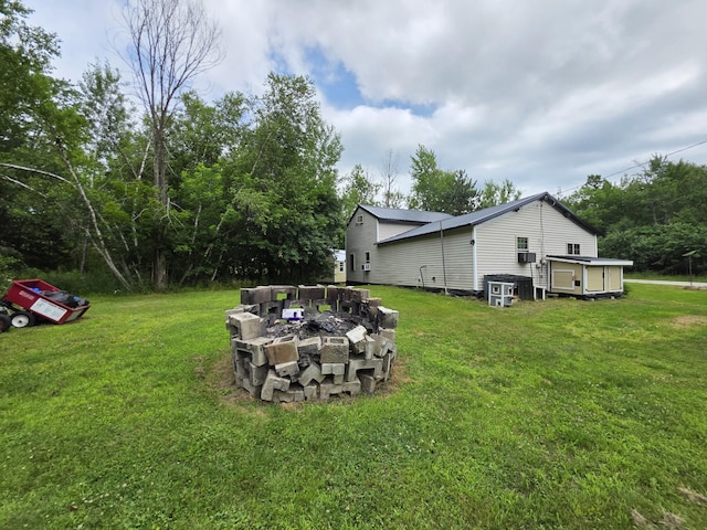 17 Cross St, Kingman Twp, ME 04451 - view of grassy yard with an outdoor fire pit