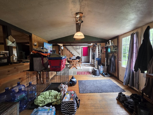 17 Cross St, Kingman Twp, ME 04451 - dining room with lofted ceiling, wood-type flooring, stairway, and a textured ceiling