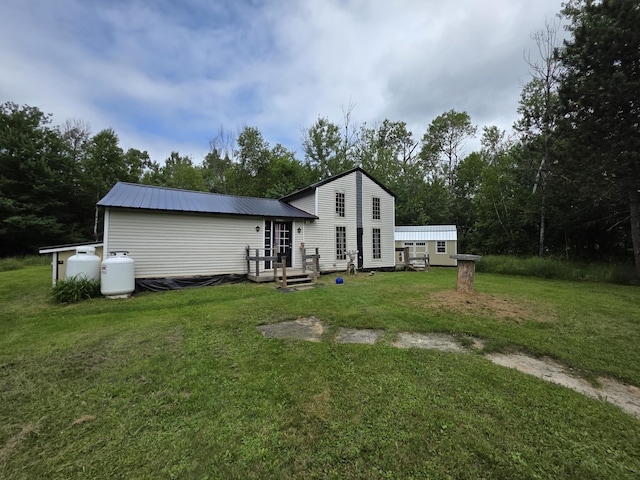 17 Cross St, Kingman Twp, ME 04451 - back of house featuring a yard and a metal roof