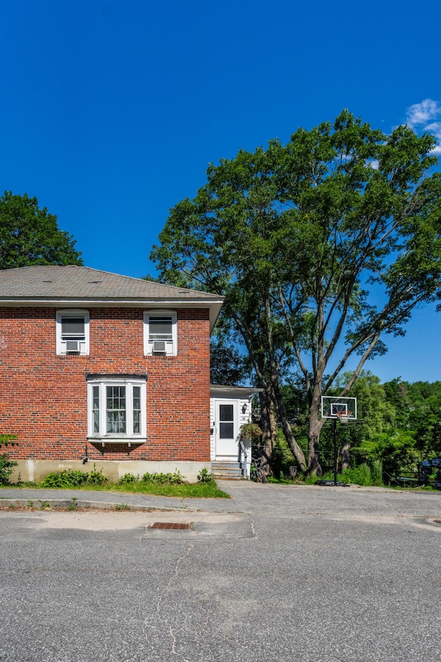 46 Meadow Way, Bath, ME 04530 - view of side of home featuring brick siding and uncovered parking