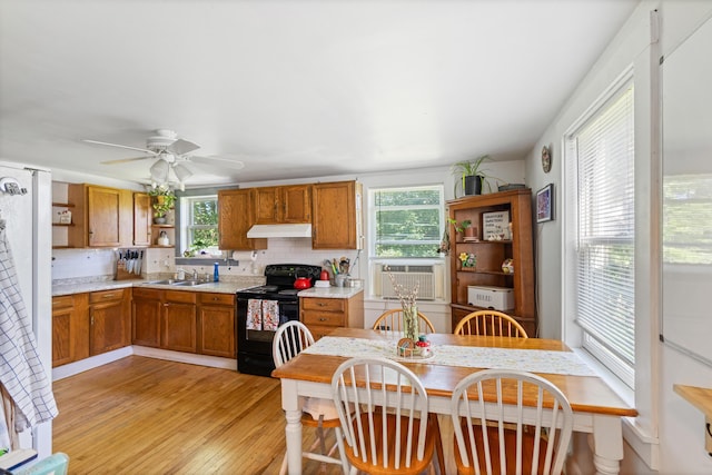 46 Meadow Way, Bath, ME 04530 - kitchen featuring black electric range oven, open shelves, under cabinet range hood, light countertops, and tasteful backsplash
