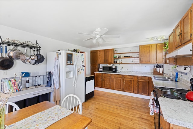 46 Meadow Way, Bath, ME 04530 - kitchen with white appliances, under cabinet range hood, open shelves, brown cabinets, and light countertops