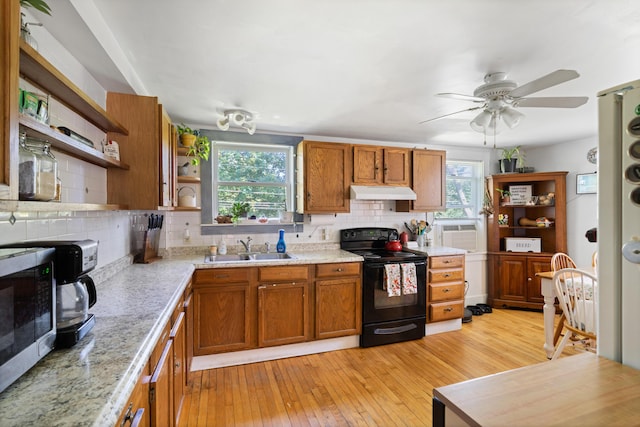 46 Meadow Way, Bath, ME 04530 - kitchen featuring black / electric stove, under cabinet range hood, open shelves, and plenty of natural light