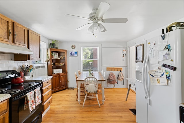 46 Meadow Way, Bath, ME 04530 - kitchen featuring black electric range oven, white refrigerator with ice dispenser, under cabinet range hood, and light wood-style floors