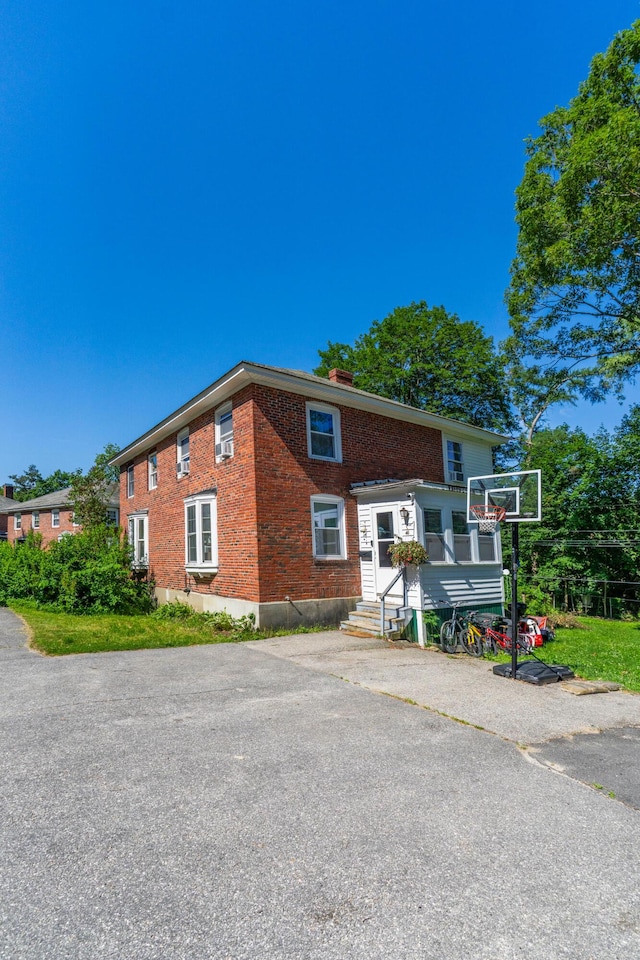 46 Meadow Way, Bath, ME 04530 - view of side of home featuring brick siding, a chimney, and entry steps