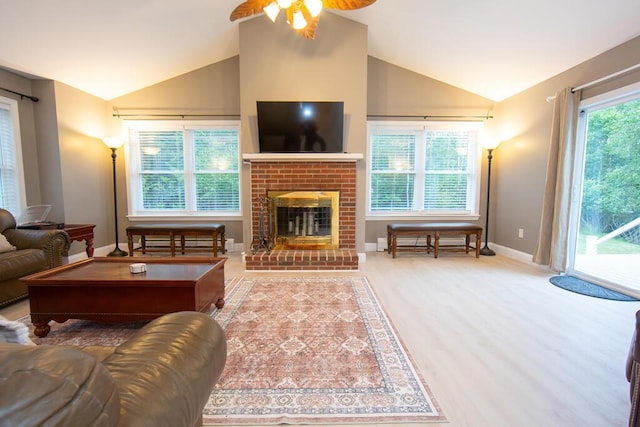 106 Sunset Bay Dr, Steuben, ME 04680 - living room featuring vaulted ceiling, a ceiling fan, and a fireplace