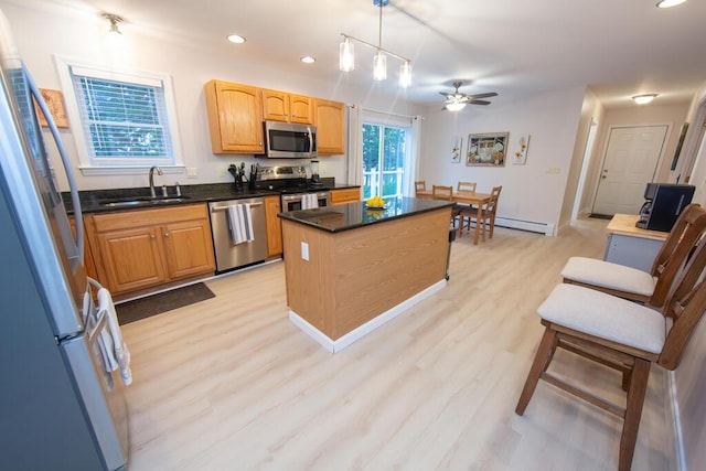 106 Sunset Bay Dr, Steuben, ME 04680 - kitchen with stainless steel appliances, a ceiling fan, recessed lighting, light wood-style flooring, and a kitchen island