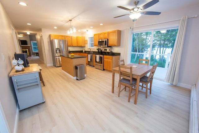 106 Sunset Bay Dr, Steuben, ME 04680 - kitchen with stainless steel appliances, dark countertops, a kitchen island, recessed lighting, and a ceiling fan