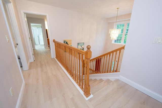 106 Sunset Bay Dr, Steuben, ME 04680 - corridor with an upstairs landing, a chandelier, and wood finished floors