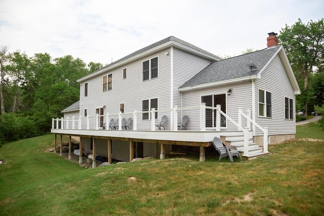 106 Sunset Bay Dr, Steuben, ME 04680 - rear view of house with a chimney, roof with shingles, a lawn, and a wooden deck