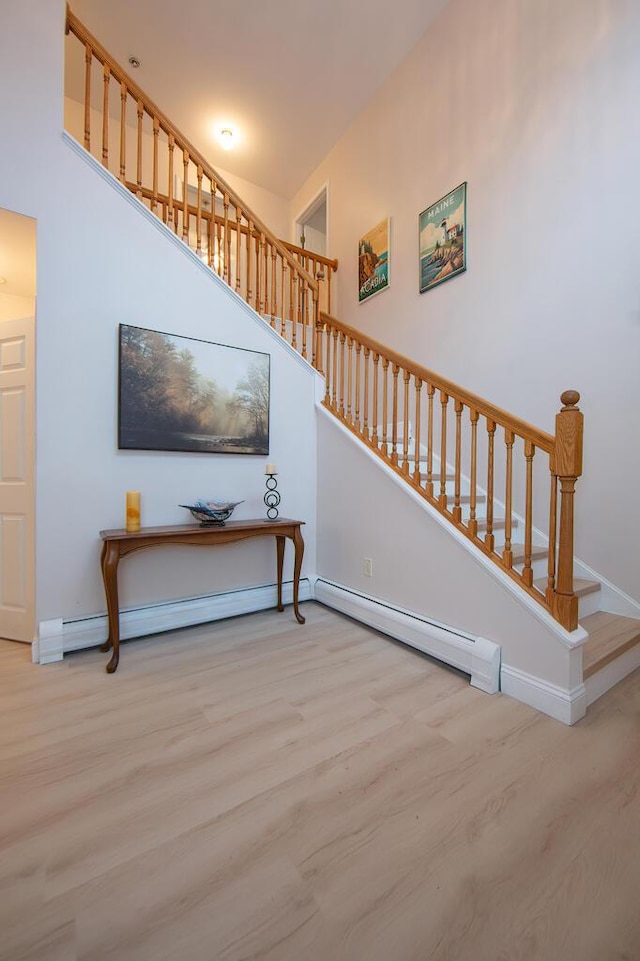 106 Sunset Bay Dr, Steuben, ME 04680 - staircase featuring wood finished floors and a baseboard heating unit