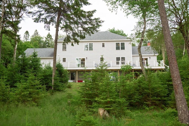 106 Sunset Bay Dr, Steuben, ME 04680 - rear view of house with a chimney, a wooden deck, and a shingled roof