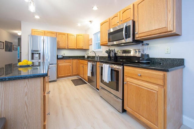 106 Sunset Bay Dr, Steuben, ME 04680 - kitchen featuring appliances with stainless steel finishes, light wood-style floors, recessed lighting, dark stone counters, and light brown cabinets