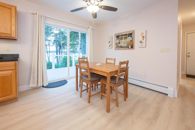 106 Sunset Bay Dr, Steuben, ME 04680 - dining room featuring a baseboard heating unit, light wood-style floors, and a ceiling fan