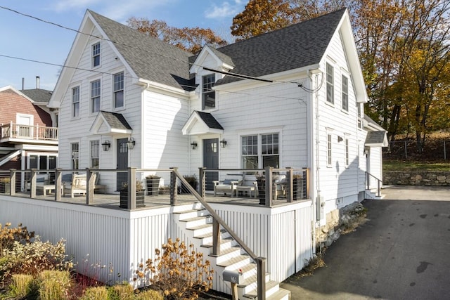38 Atlantic Ave, Boothbay Harbor, ME 04538 - view of front of property featuring stairway, a wooden deck, and a shingled roof