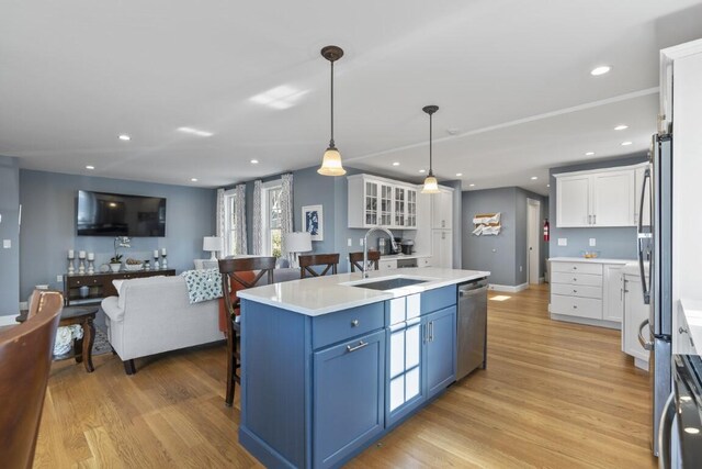 38 Atlantic Ave, Boothbay Harbor, ME 04538 - kitchen featuring dishwasher, open floor plan, white cabinets, blue cabinets, and light wood-style flooring