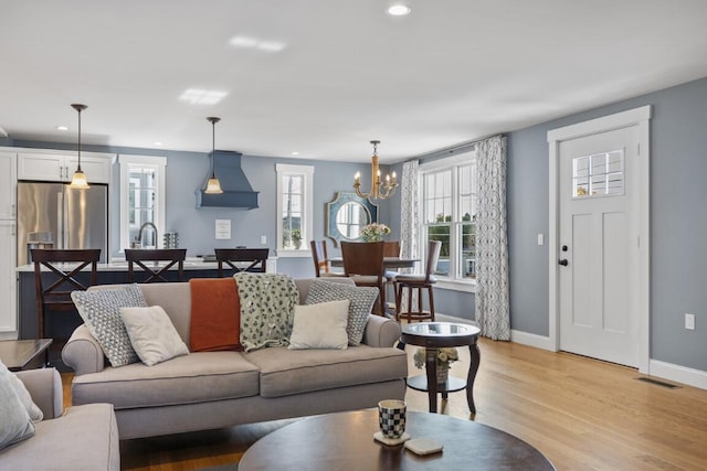 38 Atlantic Ave, Boothbay Harbor, ME 04538 - living area featuring a chandelier, recessed lighting, and light wood-type flooring