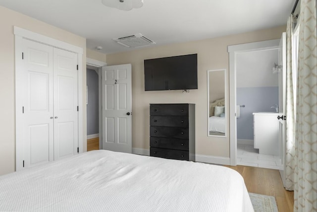 38 Atlantic Ave, Boothbay Harbor, ME 04538 - bedroom featuring a closet, wood finished floors, and ensuite bath