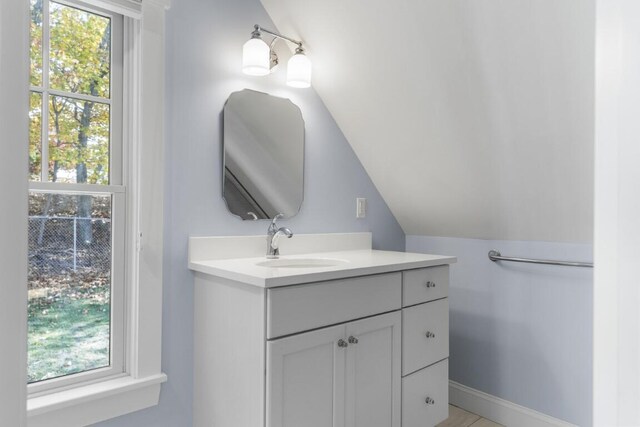 38 Atlantic Ave, Boothbay Harbor, ME 04538 - bathroom with vaulted ceiling, vanity, and healthy amount of natural light