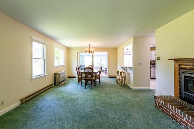 3 Curtis Ave, Camden, ME 04843 - carpeted dining area featuring a baseboard heating unit, a chandelier, and a brick fireplace