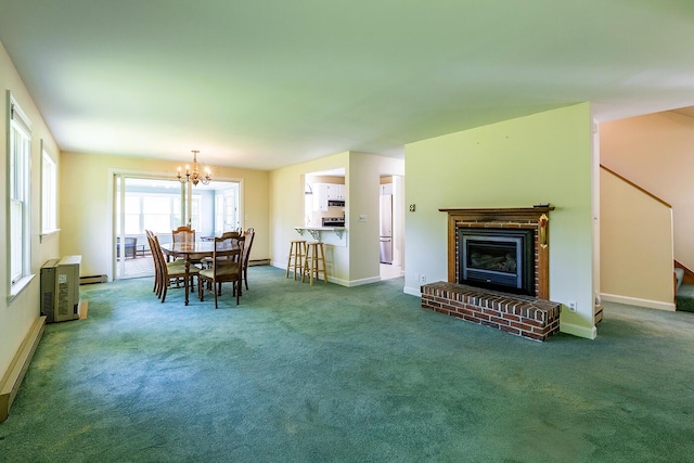 3 Curtis Ave, Camden, ME 04843 - dining room with carpet flooring, a chandelier, baseboard heating, a brick fireplace, and stairs