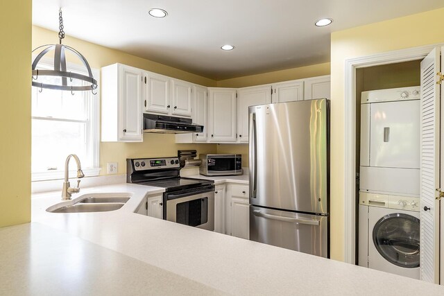 3 Curtis Ave, Camden, ME 04843 - kitchen with appliances with stainless steel finishes, stacked washer / drying machine, under cabinet range hood, light countertops, and recessed lighting