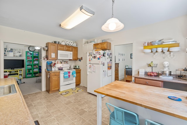 47 Fall Brook St, Portland, ME 04103 - kitchen with white appliances, a breakfast bar area, pendant lighting, and butcher block counters