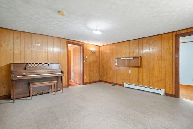 219 Mouse Ln, Alfred, ME 04002 - unfurnished room with baseboard heating, wood walls, and a textured ceiling