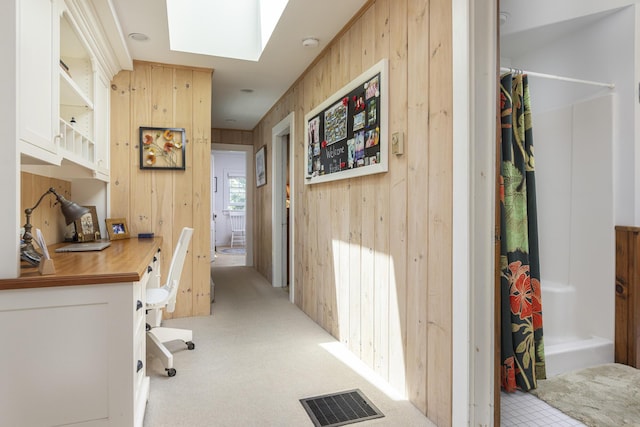 78 Seashore Ave, Portland, ME 04108 - office space featuring wooden walls, a skylight, and light colored carpet