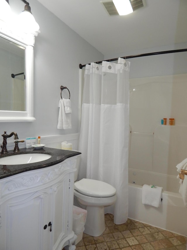 306 Eddy Rd Unit 310, Edgecomb, ME 04556 - full bath with vanity, shower / bathtub combination with curtain, wainscoting, and stone finish flooring