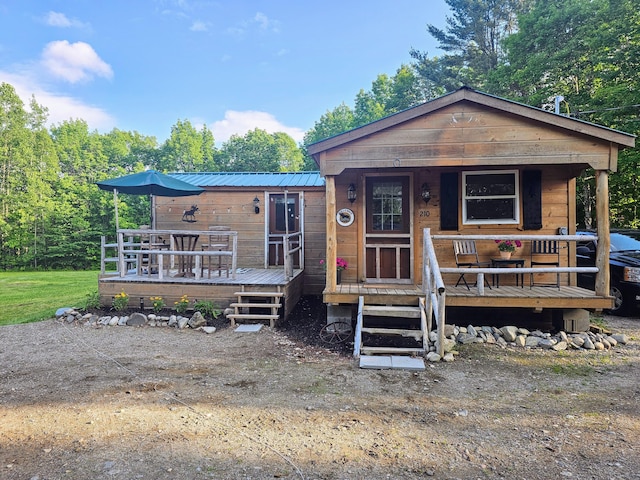210 Cobb Rd, Lee, ME 04455 - view of front of home featuring a metal roof, a porch, and a deck