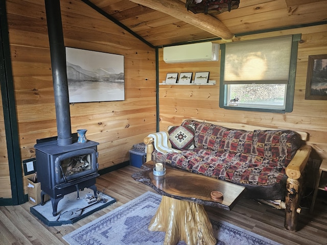 210 Cobb Rd, Lee, ME 04455 - living room with wood ceiling, a wall mounted air conditioner, wood walls, wood finished floors, and a wood stove