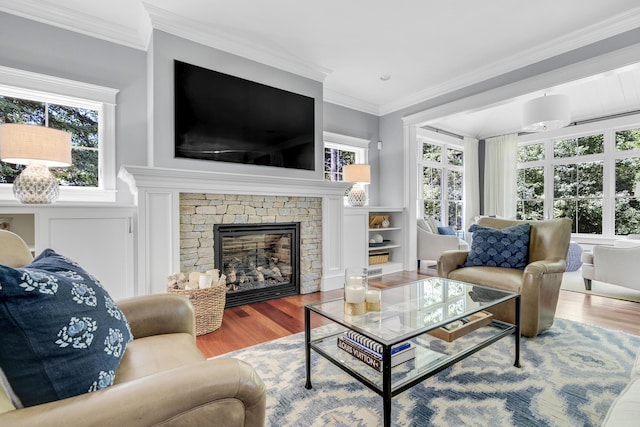 10 Paddock Way, Falmouth, ME 04105 - living area featuring wood finished floors, healthy amount of natural light, crown molding, and a stone fireplace