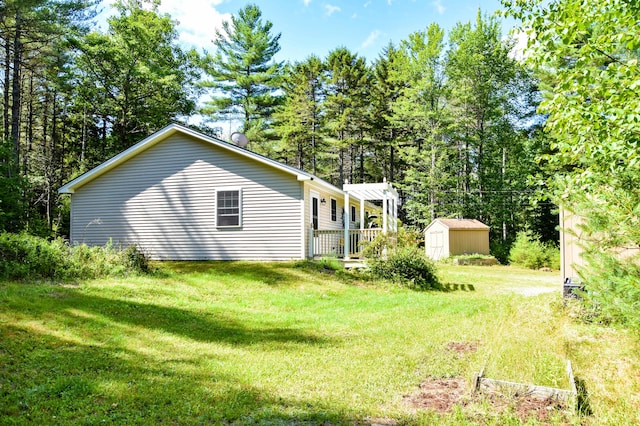 15 Good Heart Ln, Orrington, ME 04474 - view of home's exterior with a shed, a lawn, and a deck