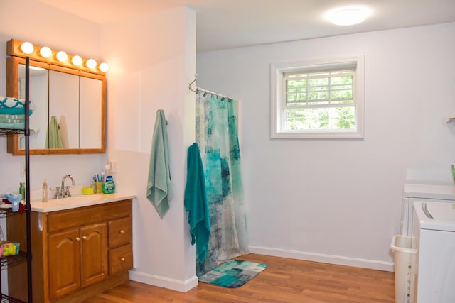 15 Good Heart Ln, Orrington, ME 04474 - full bath featuring vanity, wood finished floors, washer / clothes dryer, and a shower with curtain