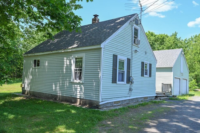 488 Bog Rd, Hermon, ME 04401 - view of side of property with roof with shingles, a chimney, an outdoor structure, a lawn, and a garage