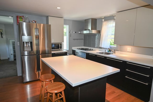 488 Bog Rd, Hermon, ME 04401 - kitchen with appliances with stainless steel finishes, wall chimney exhaust hood, plenty of natural light, wood finished floors, and recessed lighting