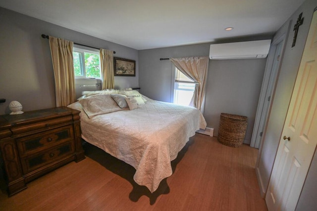 488 Bog Rd, Hermon, ME 04401 - bedroom with a wall mounted air conditioner and wood finished floors