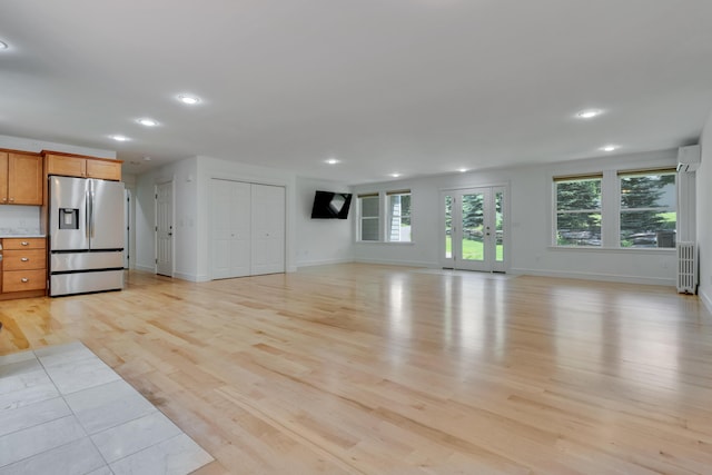 21 Cummings Way, Falmouth, ME 04105 - unfurnished living room with radiator, light wood finished floors, recessed lighting, and a wall mounted air conditioner
